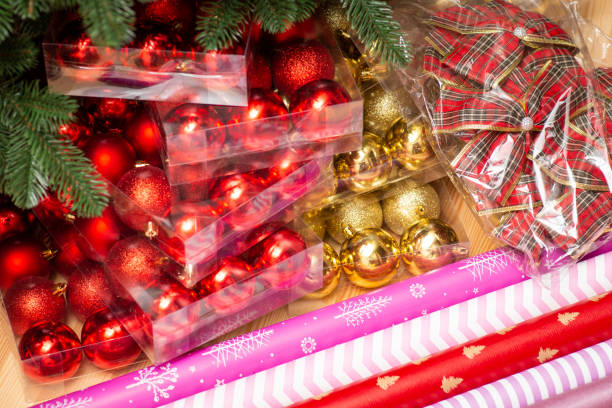 istock Christmas baubles, bows, wrapping paper on wooden table 1417296177
