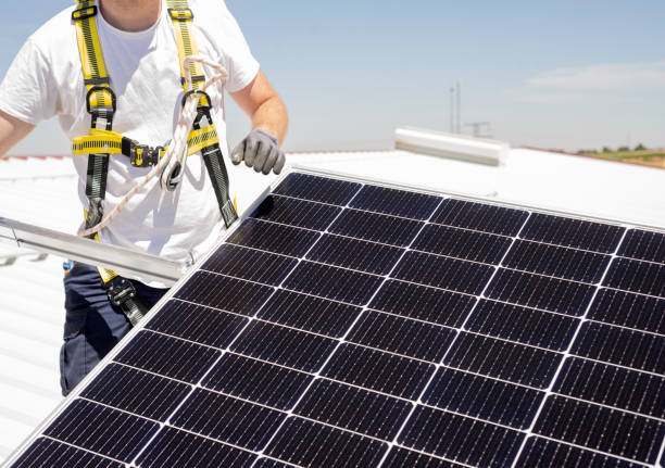 istock A worker installs solar panels on a rooftop. Renewable energy concept 1417297982