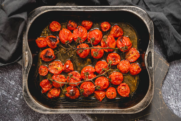 istock Baking tray with roasted cherry tomatoes with garlic, olive and thyme 1417301239