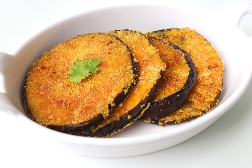 Indian side dish or appetizer Vangyache Kaap, fried Eggplants, Crispy brinjal fry, Aubergine disks, served with tomato ketchup. With copy space