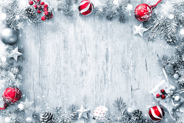 Christmas and New Year background with fir branches, gift boxes, ornament and snowfall