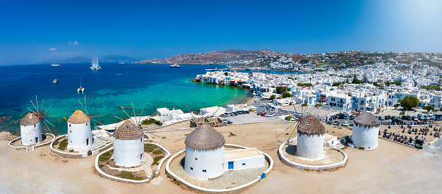 Panoramic view through the famous windmills above Mykonos town, Cyclades, Greece, to the Little Venice district