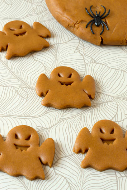 istock Cutting Halloween gingerbread in shape of ghosts 1417308971