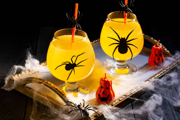 istock Halloween orange cocktail in glasses with spiders 1417309226