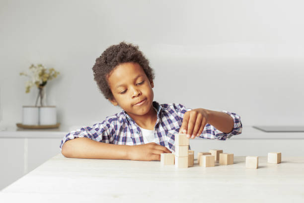 istock Child playing with wooden blocks. Kindergarten educational games. 1417309343