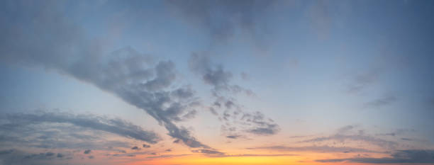 istock Golden sky with clouds and yellow twilight sunlight background 1417310575