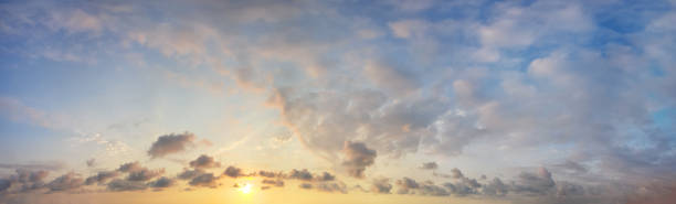 istock Warm yellow sunrise sky with dramatic clouds, panoramic background 1417310576