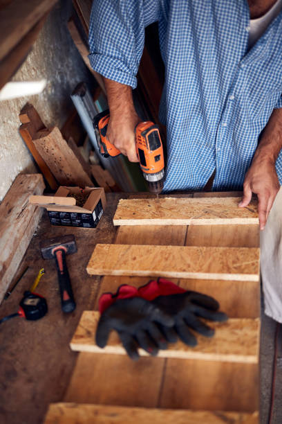 istock Man assembling furniture and fixing it - hobby concept. 1417311050