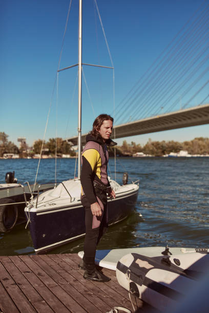 istock Windsurfer surfing on a windy day at the river. 1417311774