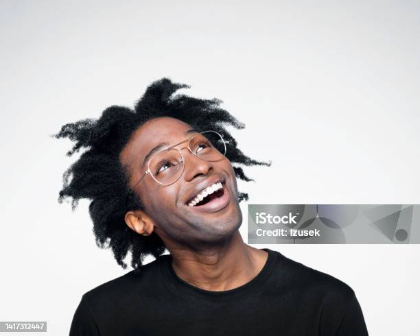 Headshot Of Excited Man In Black Outfit Stock Photo - Download Image Now - White Background, Looking Up, Human Face