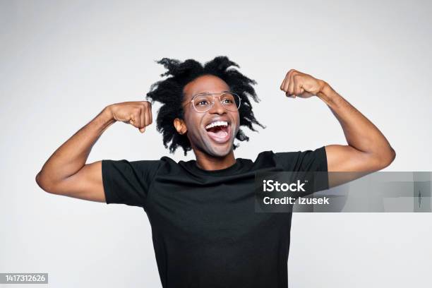 Headshot Of Excited Man In Black Outfit Stock Photo - Download Image Now - Black Color, Men, Bicep