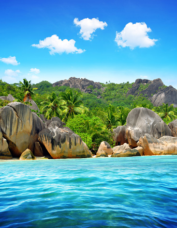 Beautiful beach Anse Source d'Argent with big granite rocks in sunny day. La Digue Island, Indian Ocean, Seychelles. Tropical destination.