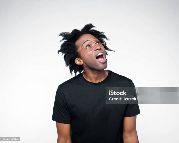 Potrait Of Surprised Man In Black Outfit Stock Photo - Download Image Now - Men, Shock, Black Color