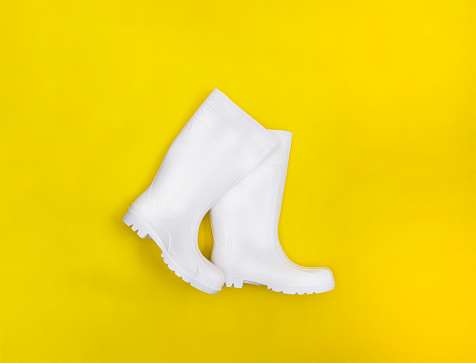White protective boots on yellow background.