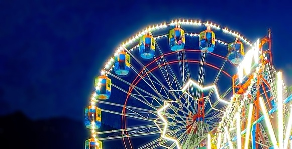Big Illuminated Wheel In Fair Night Time