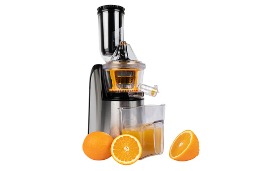 Juicer isolated on a white background. Modern stainless steel fruit and juice machine with orange an juice. Eelectric fruit and vegetable juicer isolated.