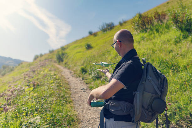 istock Man launching drone from hand in high mountains 1417319751