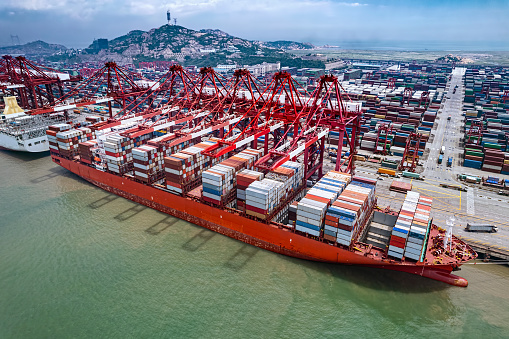 Panoramic view of a port activity with cargo ships, cranes and containers at the pier of the Port Of Cartagena, Colombia.