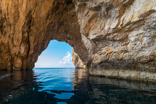 The Blue Grotto is a complex of sea caves along the Southeastern part of Malta, and on sunny days, the reflection of sunlight on the white sandy seafloor lights up the caves in bright blue hues