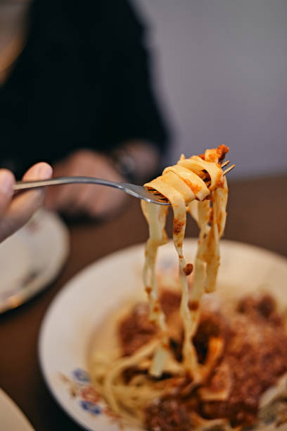 istock woman hand holding pasta 1417323382
