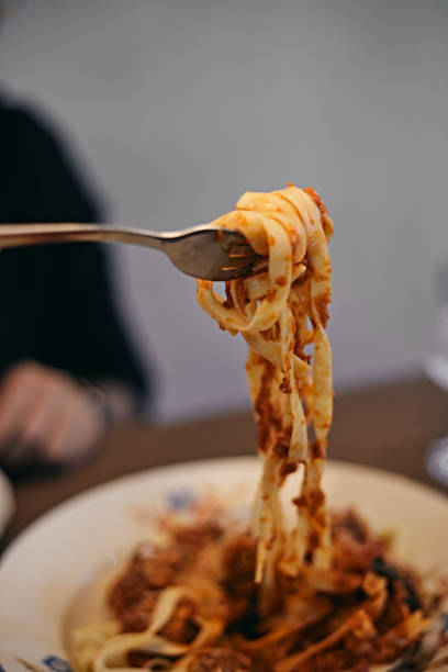 istock woman hand holding pasta 1417323470
