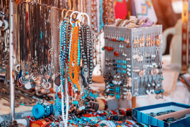 costume jewelry and beads and bracelets at the flea market are for sale. stock photo