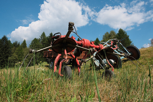 A tedder used for hay making. An ancient agricultural machine, also called a spider, was used to move the hay so that it could dry better.