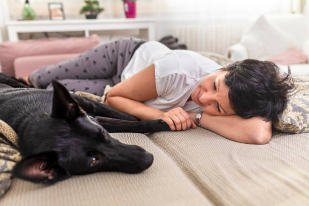 istock Woman cuddling with her dog 1417324407