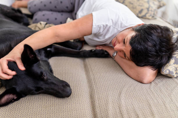 istock Woman cuddling with her dog 1417324413