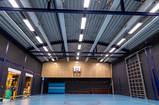 An empty school gymnasium, low angle view.