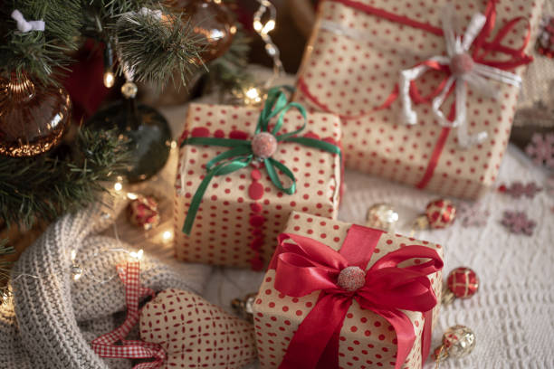 istock Festive gift boxes under the Christmas tree, close-up. 1417326932