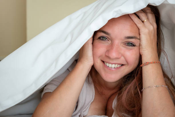 istock Happy woman under the sheets 1417326965