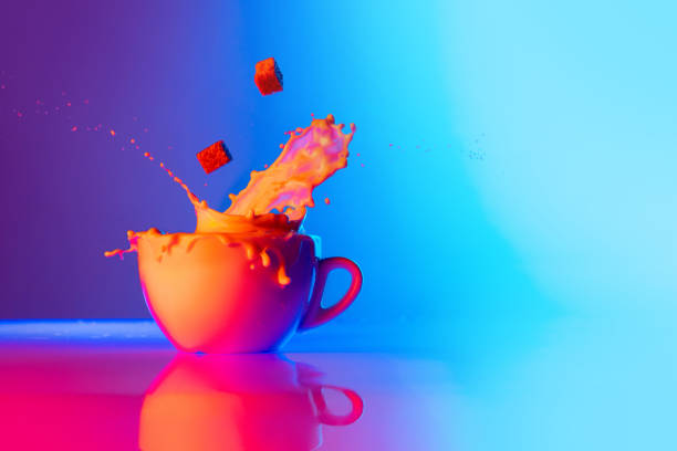 istock Sugar please. Cup of coffee with milk standing on mirror surface over gradient blue white background in neon light. Concept of art, beauty, drinks 1417328479