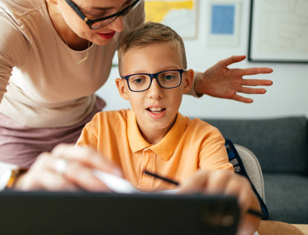 istock An Anonymous Mother Helping Her Son With A New Lesson On A Tablet At Home 1417328853