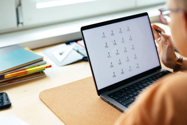 istock Anonymous Mother Helping Her Son With A Homework On A Laptop Computer 1417328890