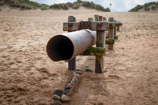 Sewage outlet on Seaton Sluice beach, in the background are the sand dunes and marram grass.