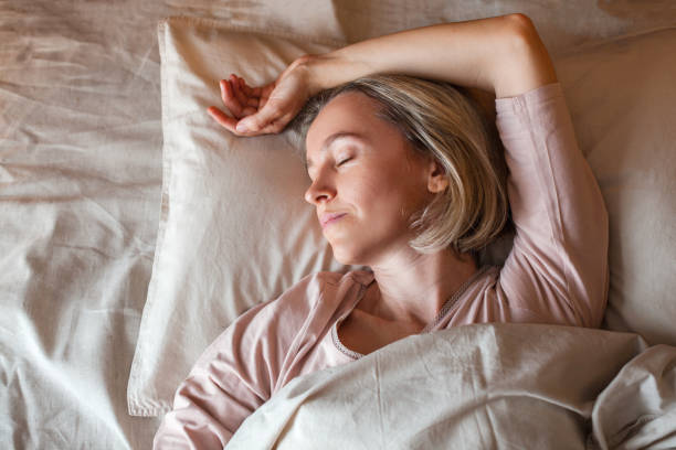 istock Middle aged woman sleeping in cozy bed 1417335529