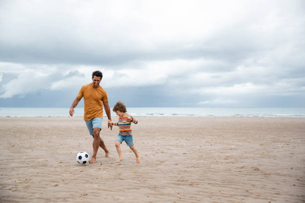 istock Father and Son Playing Football 1417336783