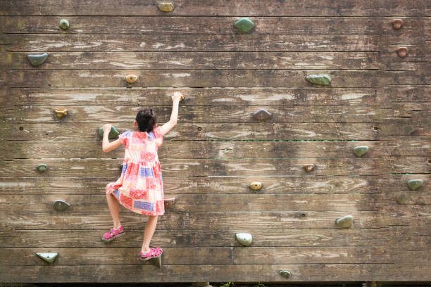 istock Girl climbing the wall 1417337693