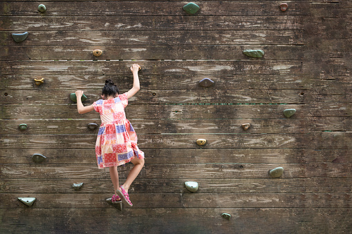 Girl climbing the wall