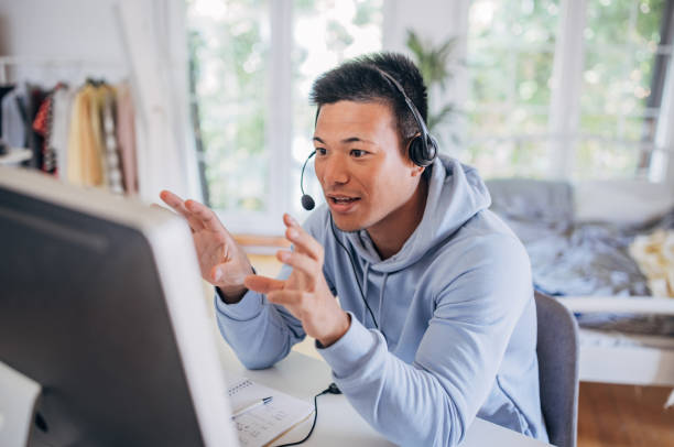 ビデオ通話中の男 - working at home headset telecommuting computer ストックフォトと画像
