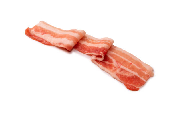 istock Raw bacon slices isolated on a white background. 1417341490