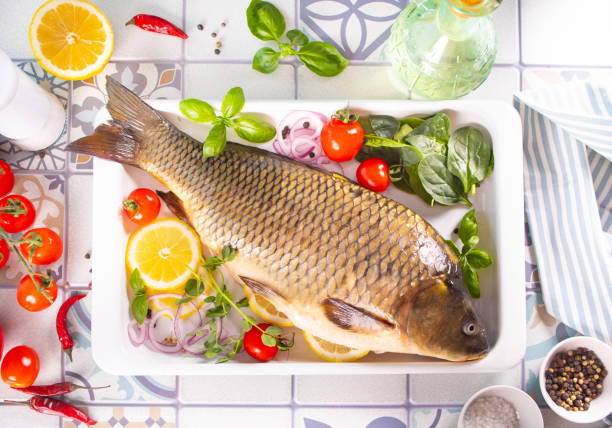 Fresh tasty raw seafood fish served on old blue wooden table with cooking ingredients. Top view. Copy space. stock photo