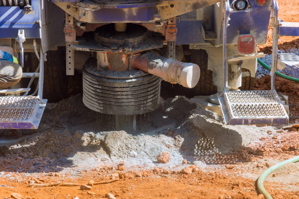 portable hydraulic water well drilling rig with water extraction on a private plot - borehole imagens e fotografias de stock