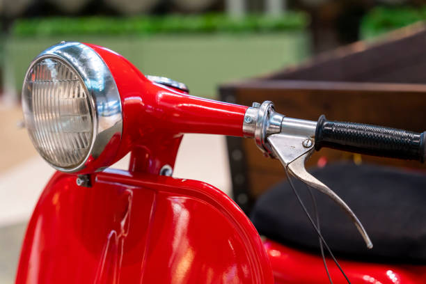 istock headlight, handlebar and control levers of a vintage red scooter. 1417346748