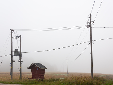 A foggy morning in the countryside in Finland, there is a milk dock and electric wires running through the air. Milk docks were in use in Finland from 1920 to 1970, but are no longer in use today. Tanks containing milk were taken to the milk dock to wait for the milk truck.