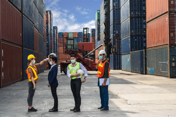 istock Engineer worker wearing surgical mask checking body temperature using infrared digital thermometer check temperature before into workplace, workers with protective mask 1417349642