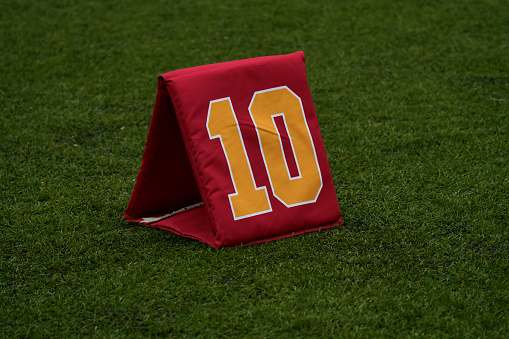 Close-up detail of a yard marker standing on a soccer field. Team sport concept
