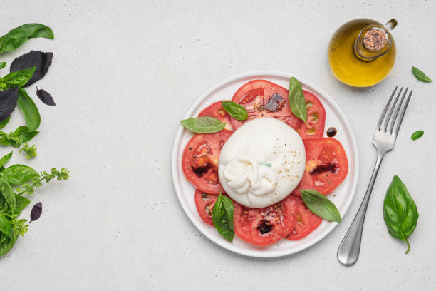 istock Tomato salad with buratta cheese or mozzarella and basil. 1417353617