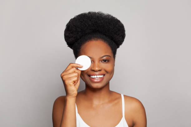 istock Happy young woman spa model using cotton pads 1417354681
